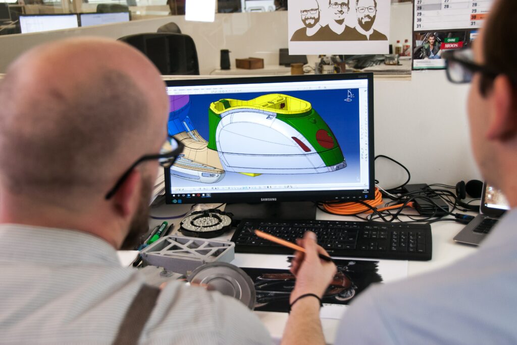 engineers using rapid prototyping and digital fabrication to design a product on a computer